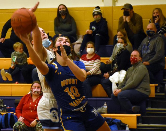 Caroline Entwistle (10) attempts a shot for Mt. Markham with Madison Obreza defending for Central Valley Academy during the second half of the Richfield Springs Holiday Tournament championship game Thursday. Mt. Markham won the tournament and  Entwistle was named the most valuable player.