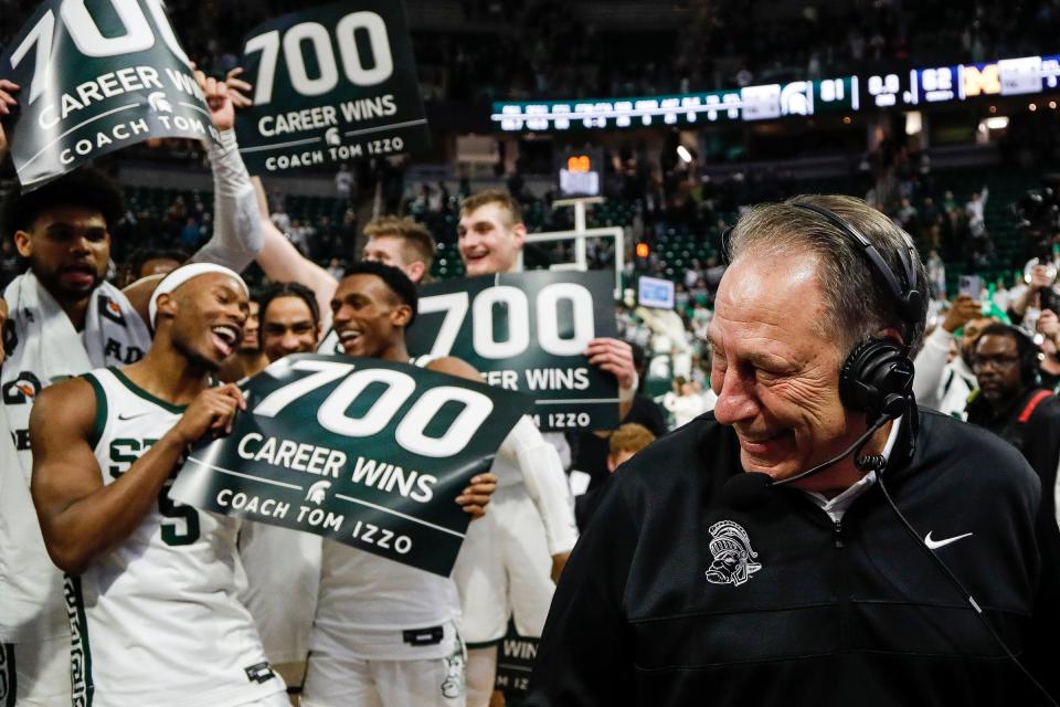 Michigan State players celebrate head coach Tom Izzo's 700th career win as head coach Tom Izzo is being interviewed after MSU's 81-62 win over Michigan at Breslin Center in East Lansing on Tuesday, Jan. 30, 2024.