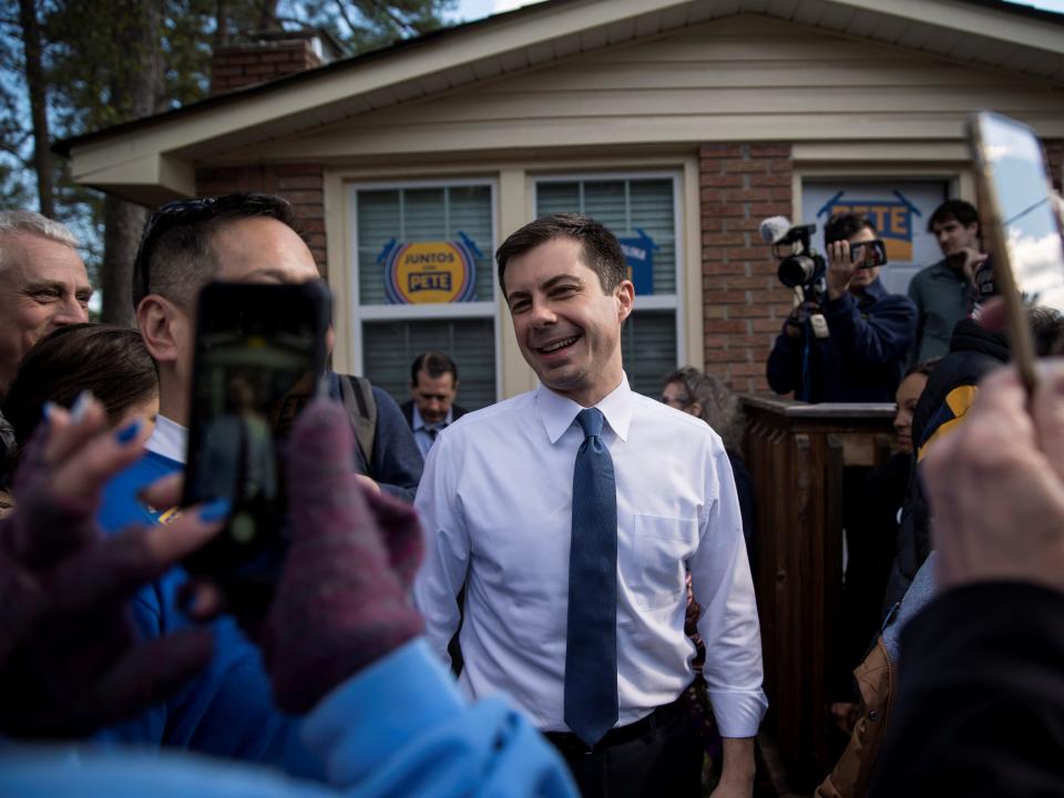 Buttigieg in a crowd by a house .JPG