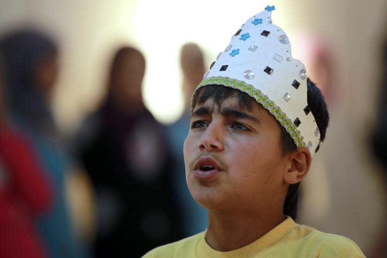 Syrian refugee Majd Ammari, 13, acts in the role of King Lear during a rehearsal of one of Shakespeare's great tragedies, at the sprawling Zaatari refugee camp in Jordanian desert near the border with Syria, on March 8, 2014