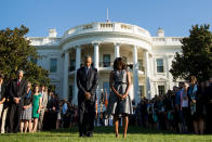 <p>President Barack Obama, first lady Michelle Obama, and others, pause on the South Lawn of the White House in Washington, Friday, Sept. 11, 2015, as they observe a moment of silence to mark the 14th anniversary of the 9/11 attacks. (AP Photo/Andrew Harnik) </p>