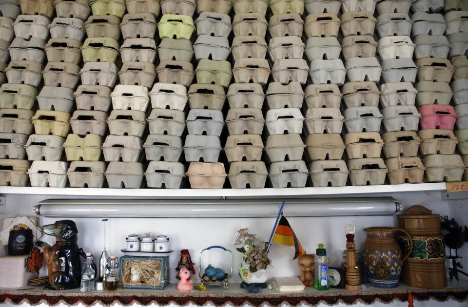 Egg boxes for storing Easter eggs are stacked in a room of German pensioners Christa and Volker Kraft's summerhouse in the eastern German town of Saalfeld, March 19, 2014. Each year since 1965 Volker and his wife Christa spend up to two weeks decorating the tree with their collection of 10,000 colourful hand-painted Easter eggs in time for Easter celebrations. REUTERS/Fabrizio Bensch