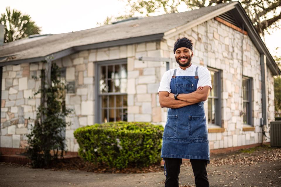 Chef Leon C. Brunson poses in front of his new restaurant, Leon's, at Lake Ella.