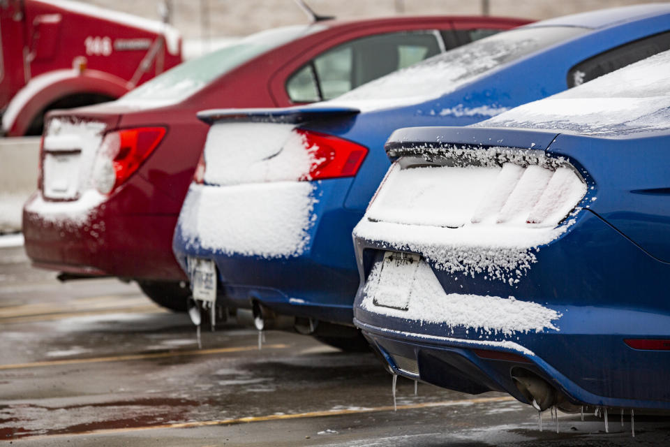 Vehicles dowsed in snow are parked in the parking lot off Mose Avenue Friday, Feb. 12, 2021, in Odessa, Texas. Friday is the second day the Permian Basin has seen freezing weather as a Winter Weather Advisory issued by the National Weather Service for the region remains in effect until 11 a.m. Saturday. (Jacob Ford/Odessa American via AP)