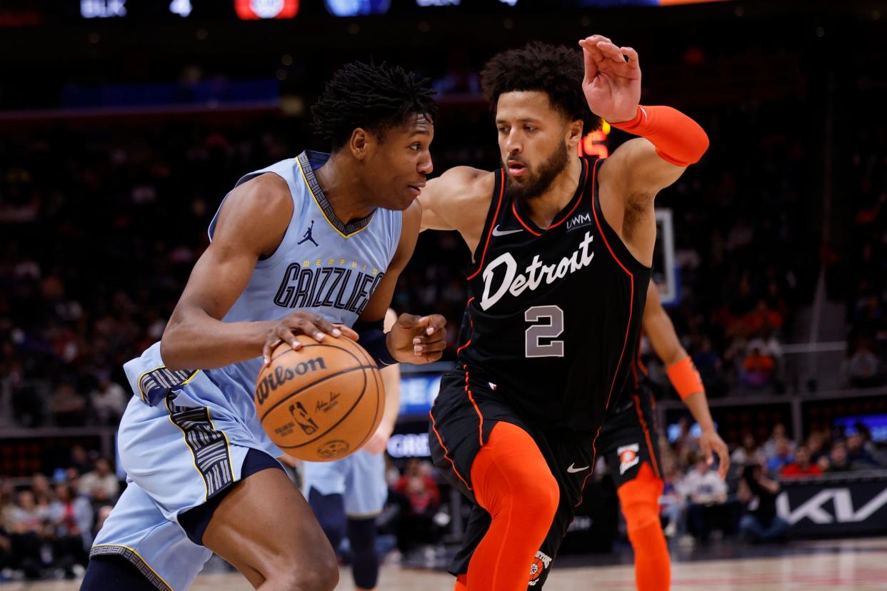 Grizzlies forward GG Jackson dribbles defended by Pistons guard Cade Cunningham in the second half of the Pistons' 110-108 loss on Monday, April 1, 2024, at Little Caesars Arena.