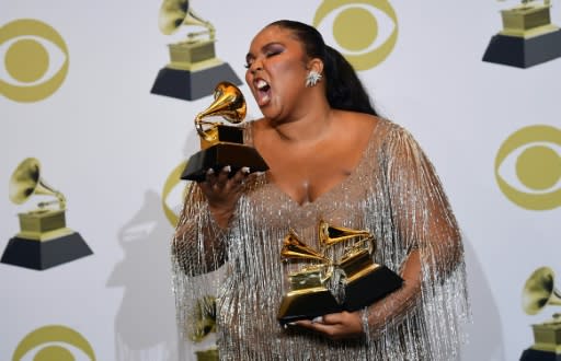 Lizzo poses in the Grammys press room with her three awards