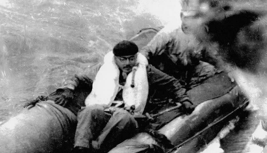 Netaji Bose being transferred from a German submarine to a Japanese submarine via a rubber raft.