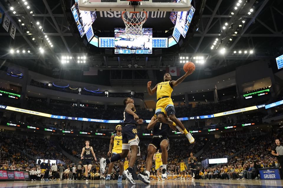 Marquette's Kam Jones shoots past Notre Dame's Markus Burton during the first half of an NCAA college basketball game Saturday, Dec. 9, 2023, in Milwaukee. (AP Photo/Morry Gash)