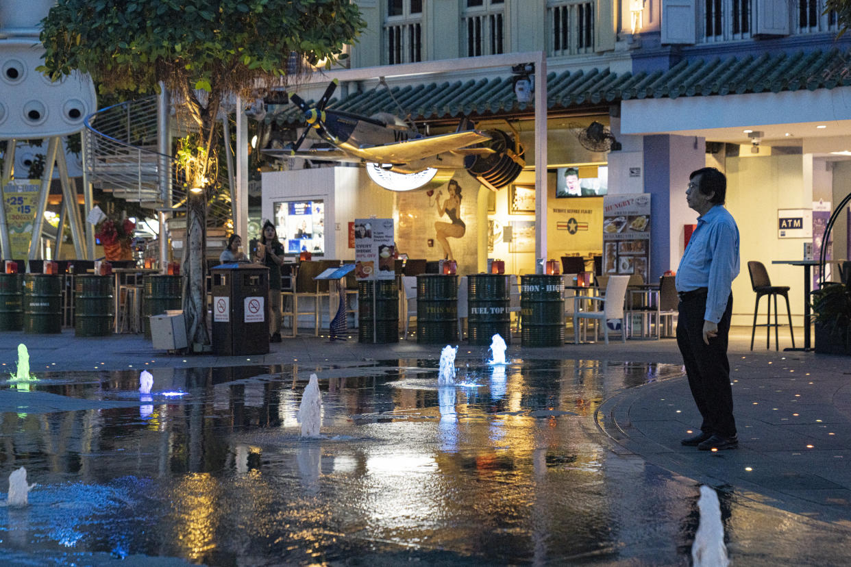 SINGAPORE, SINGAPORE - MARCH 30: A man looks at the water fountain in Clarke Quay on March 30 2020 in Singapore. The usually popular drinking area has seen less crowd since the Singapore government shut down all entertainment venues such as bars, karaoke lounges, nightclubs and introduced several safe distancing measures to curb the spread of COVID-19. The Coronavirus (COVID-19) pandemic has spread to many countries across the world, claiming over 20,000 lives and infecting hundreds of thousands more. (Photo by Ore Huiying/Getty Images)