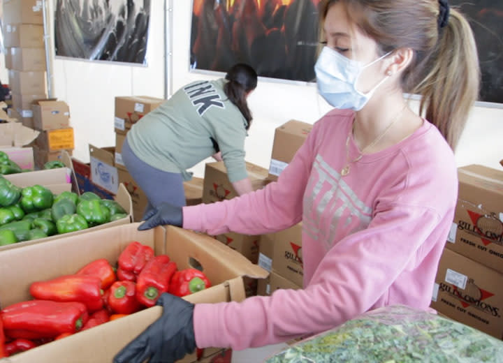 Volunteers help sort food for delivery during the coronavirus pandemic