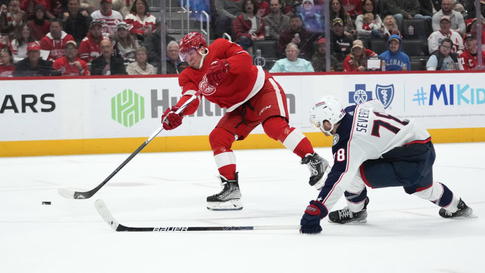 Detroit Red Wings right wing Daniel Sprong (88) shoots to score as Columbus Blue Jackets defenseman Damon Severson (78) defends in the second period of an NHL hockey game Saturday, Nov. 11, 2023, in Detroit. (AP Photo/Paul Sancya)
