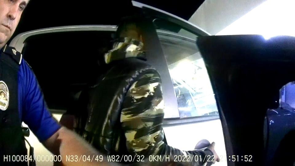 An unknown man is seen talking to Sam Hendrix's daughter between Sgt. Greg Stroud and Officer Ronald Bartlett in Bartlett's body camera footage.