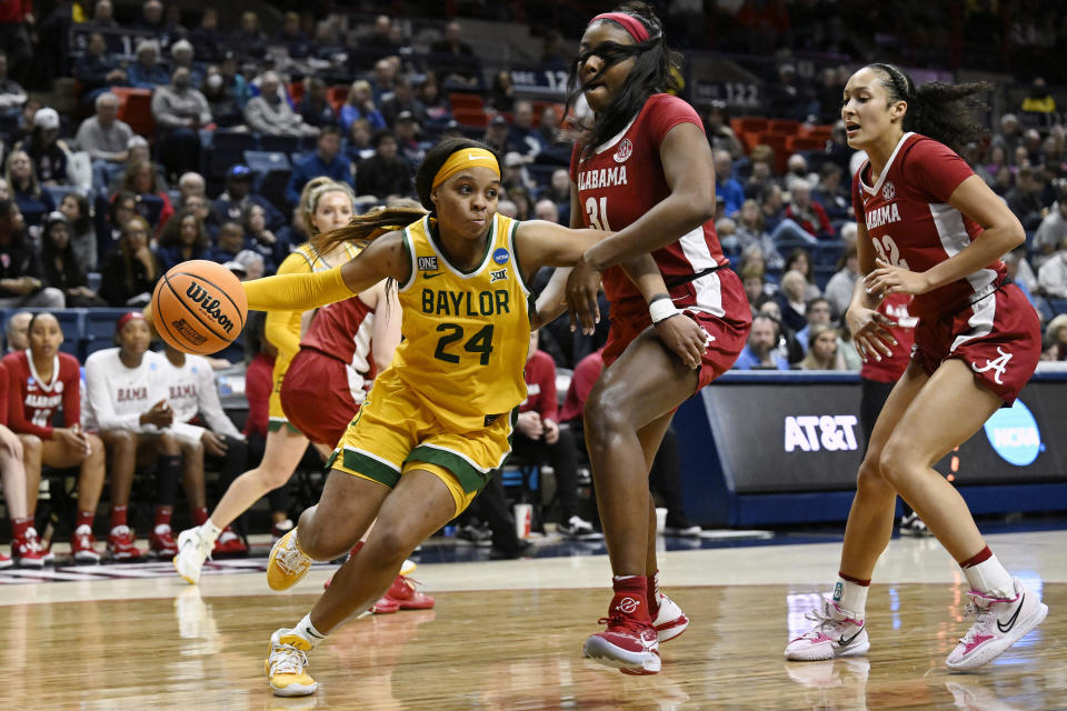 Baylor's Sarah Andrews (24) dribbles around Alabama's Jada Rice (31) in the first half of a first-round college basketball game in the NCAA Tournament, Saturday, March 18, 2023, in Storrs, Conn. (AP Photo/Jessica Hill)