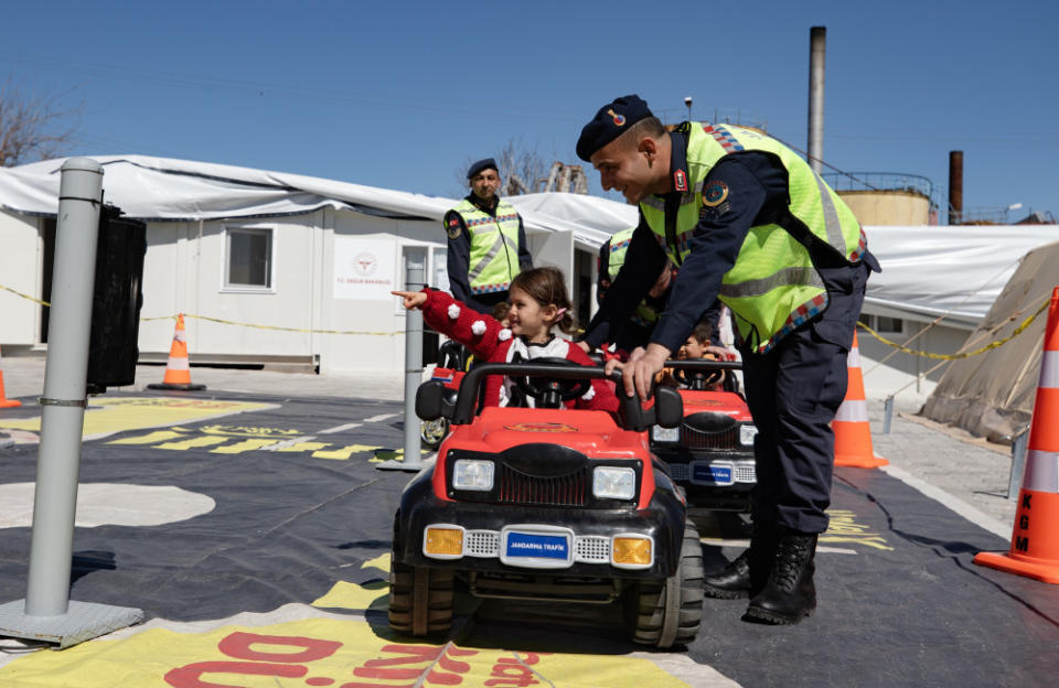 Traffic crew of Turkish Gendarmerie General Command rally together to conduct activities for young survivors of the earthquake that ravaged Turkey in February. Children are taught the rules of the road in a mobile traffic training lorry truck.