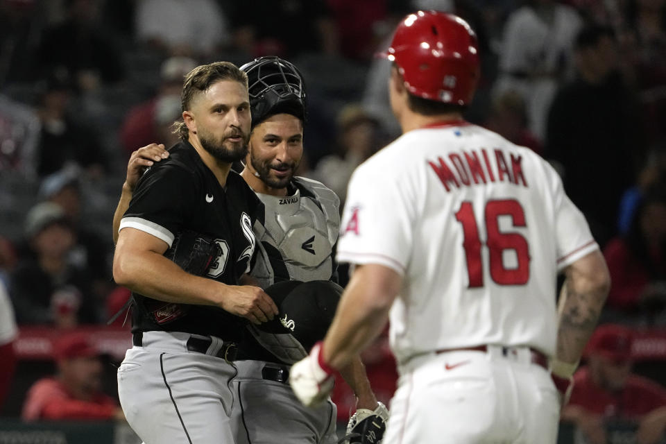Chicago White Sox relief pitcher Kendall Graveman, left, and catcher Seby Zavala, center, congratulate each other, while Los Angeles Angels' Mickey Moniak, right, runs off the field after he flied out to end the baseball game Wednesday, June 28, 2023, in Anaheim, Calif. (AP Photo/Mark J. Terrill)