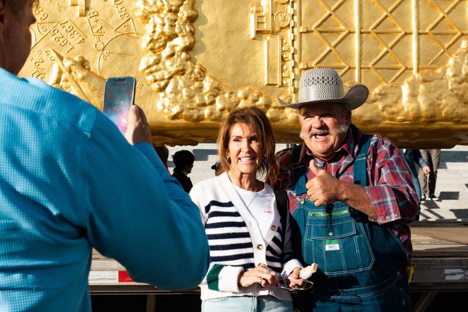 James Van Orman, the driver who brought the Golden Spike Monument to Utah, and Karen Keller, The Golden Spike Foundation committee member, take a photo together after the Golden Spike Monument’s arrival in front of the Utah state Capitol in Salt Lake City on Monday, Oct. 23, 2023. The 43-foot-tall golden spike was commissioned as a public art piece by the Golden Spike Foundation to honor the tens of thousands of railroad workers who built the transcontinental railroad. | Megan Nielsen, Deseret News