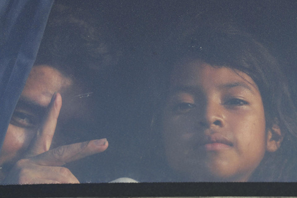 In this July 18, 2019 photo, migrant Antonio Herrera, a former police officer from Honduras, and his 7-year-old daughter, sit in a bus chartered by Mexican immigration authorities, that will take them from Nuevo Laredo to Monterrey, Mexico. Critics assert that Mexico has become a de facto dumping ground for asylum seekers and migrants whom the Trump administration is eager to remove from U.S. soil. (AP Photo/Marco Ugarte)