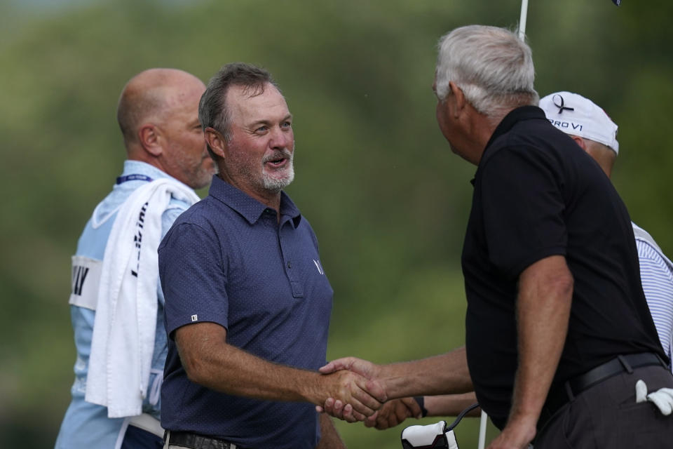 Jerry Kelly greets Kirk Triplett, right, after defeating Triplett in a playoff to win the PGA Tour Champions Principal Charity Classic golf tournament, Sunday, June 5, 2022, in Des Moines, Iowa. (AP Photo/Charlie Neibergall)