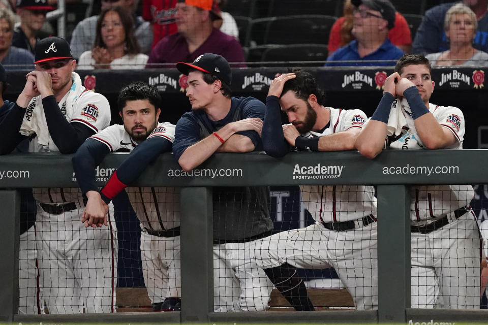 The Atlanta Braves watch from the dugout in the ninth inning of their 5-4 loss to Colorado Rockies in a baseball game Tuesday, Sept. 14, 2021, in Atlanta. (AP Photo/John Bazemore)