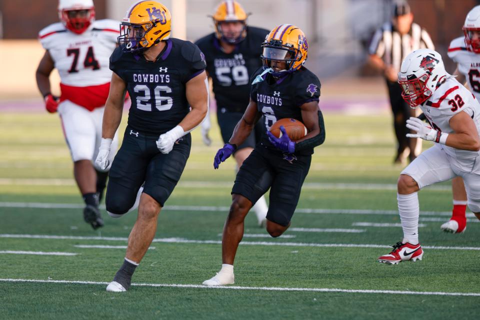 HSU's K.J. Peoples (6) looks for running room while Hawley grad Colton Marshall (26) runs alongside him against Albright. The Cowboys beat Albright 47-3 in the season-opening game Friday at Shelton Stadium.