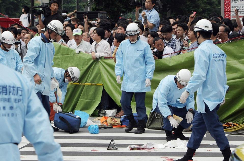 Emergency responders at the site of Kato’s killing spree (AFP/Getty)