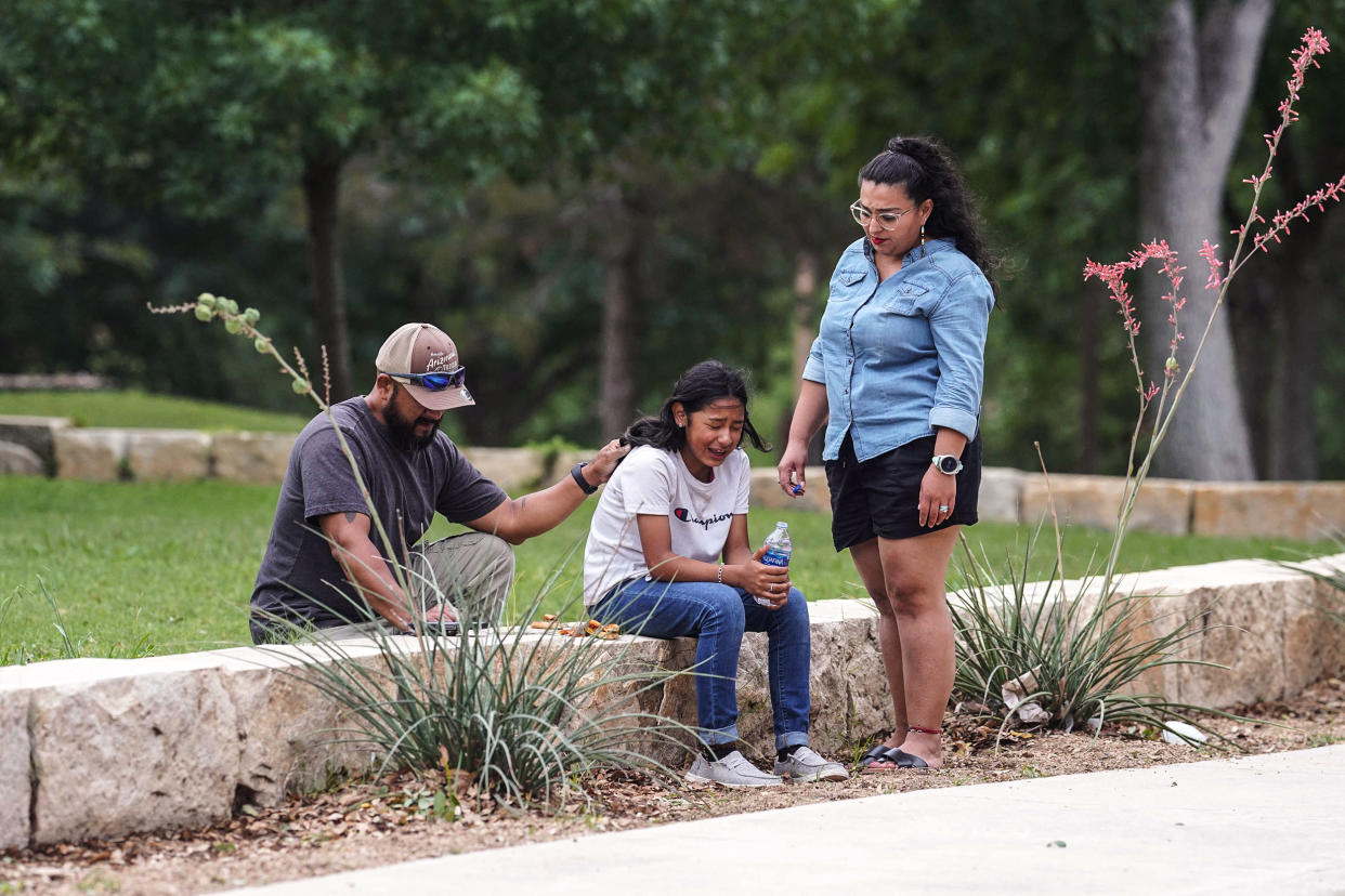 Image: A girl cries, comforted by two adults, outside the Willie de Leon Civic Center where grief counseling will be offered in Uvalde, Texas, on May 24, 2022. (Allison Dinner / AFP - Getty Images)