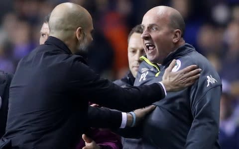 Pep Guardiola and Paul Cook - FA poised for investigation after Sergio Aguero clashes with invading fan after Manchester City's Cup exit at Wigan - Credit: Action Images