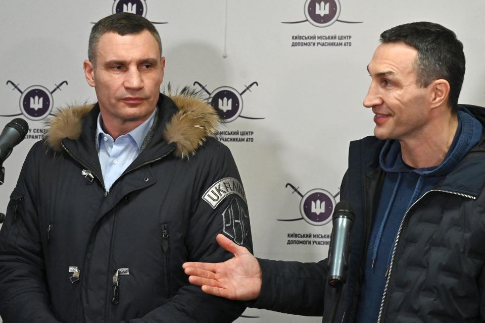 Kyiv mayor Vitali Klitschko (L) and his brother and former Ukrainian boxer Wladimir Klitschko (R) speak to the press during visit to a volunteers recruitment centre in Kiev on February 2, 2022. - Kyiv mayor and former world heavyweight champion boxer Vitaly Klitschko along with his brother, fellow champion boxer, Wladimir visited a recruitment centre for volunteers willing to take up arms if the capital is attacked. (Photo by Genya SAVILOV / AFP) (Photo by GENYA SAVILOV/AFP via Getty Images)