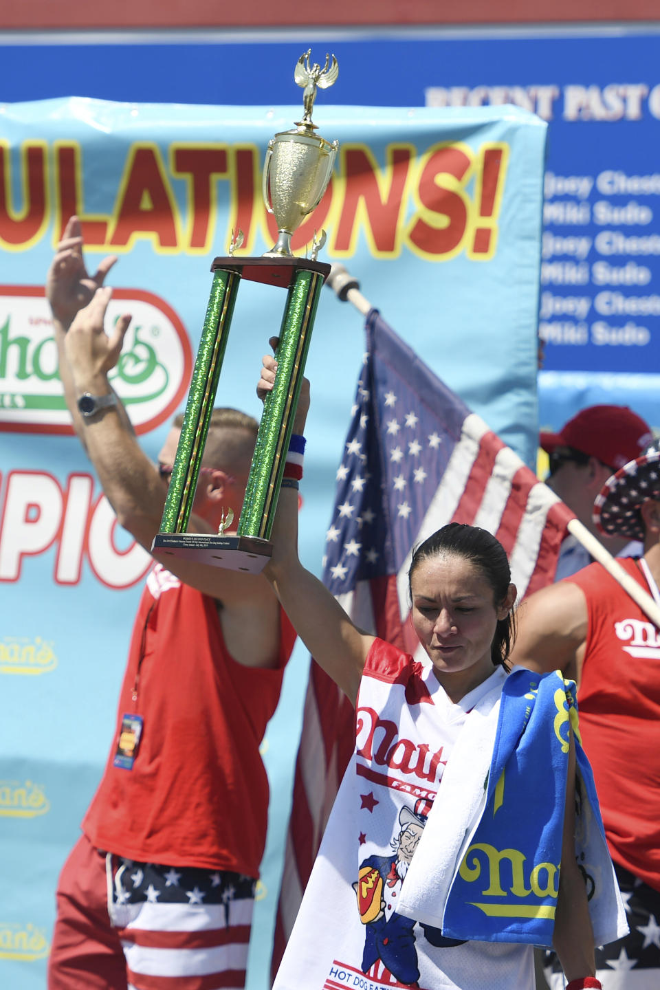 Michelle Lesko reacts after receiving her second-place trophy after the women's competition of Nathan's Famous July Fourth hot dog eating contest, Thursday, July 4, 2019, in New York's Coney Island. (AP Photo/Sarah Stier)