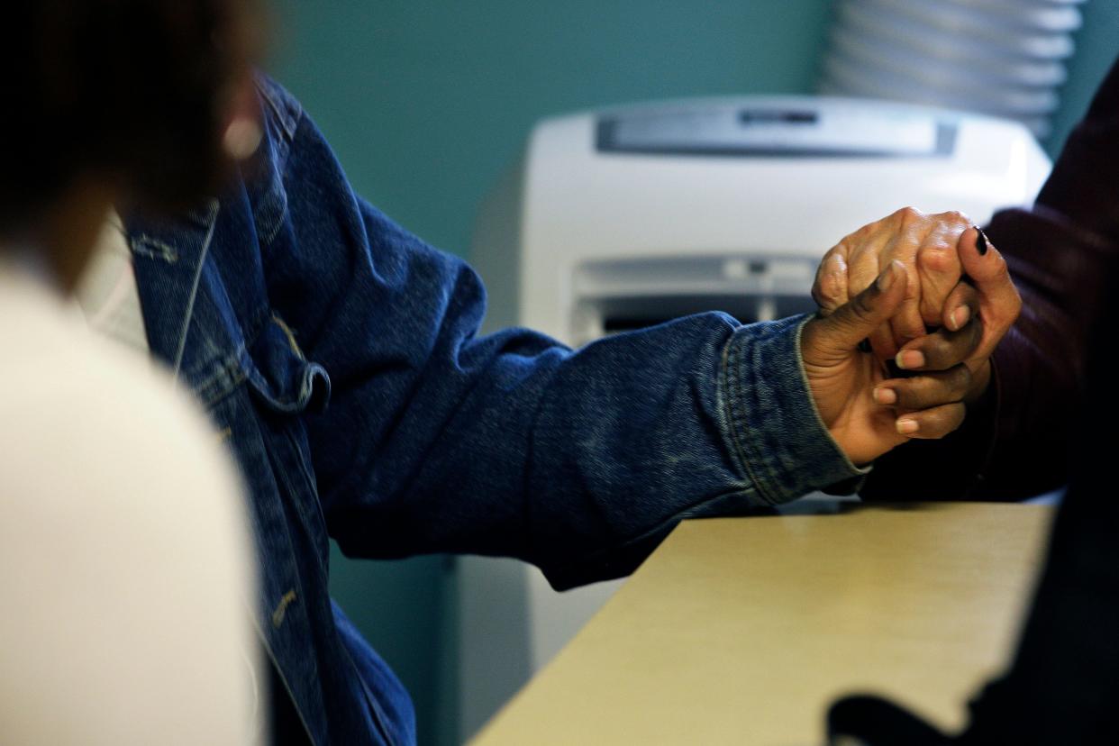 Donna Hietpas comforts one of the women attending a Sisters Program group session at the Benedict Center at Reformation Lutheran Church. The Sisters Program is designed to help women engaged in street prostitution begin a journey toward a healthier, safer life.