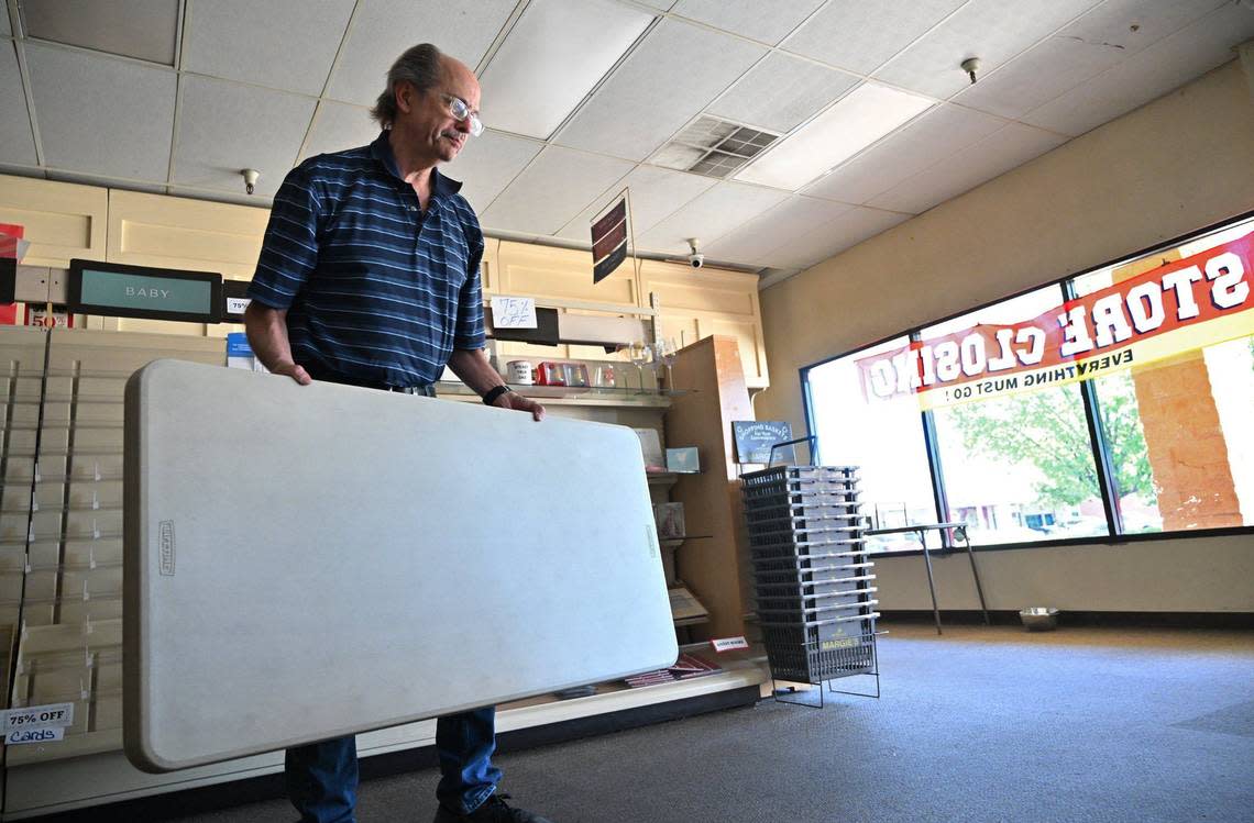 Tom Pearce, owner of Margie’s Hallmark Shop, continues clearing out the store his parents opened 37 years ago near Clovis Avenue and Kings Canyon Road Friday in Fresno. After decades of service, Pearce has closed the shop.