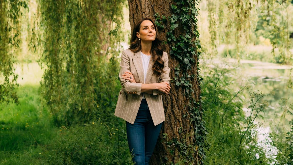 Kate Middleton standing next to tree