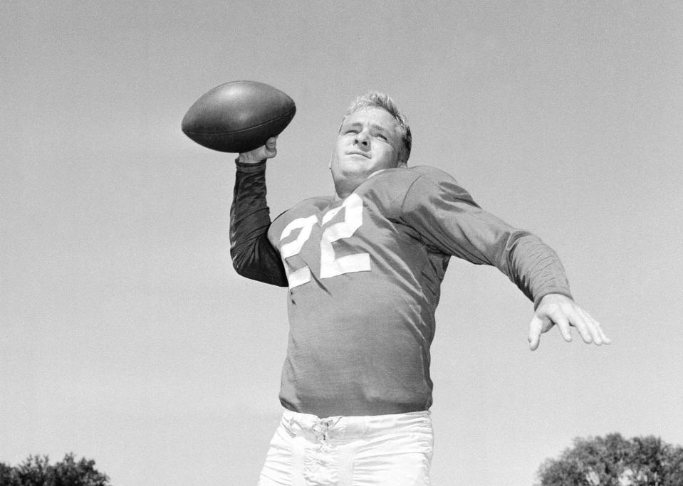 Bobby Layne, quarterback for the Detroit Lions, is shown passing at the Lions' camp in Ypsilanti, Mich., July 22, 1954.