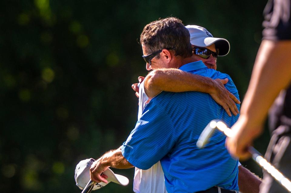 The team of Jeffrey and Kevin Silva embrace following their victory of the CCNB Fourball Tournament.