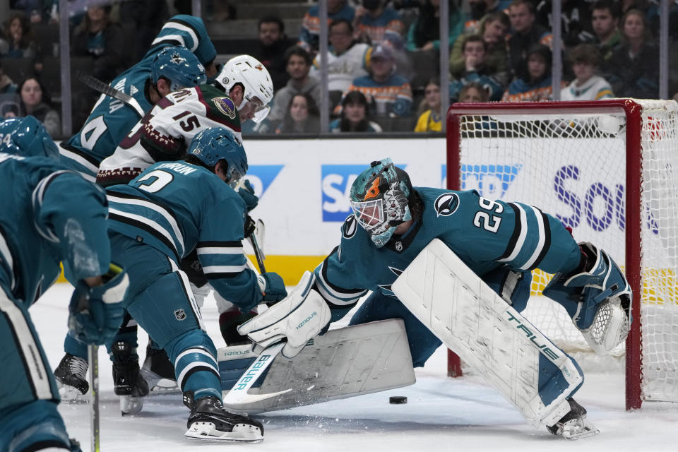 Arizona Coyotes center Alexander Kerfoot (15) scores against San Jose Sharks goaltender Mackenzie Blackwood (29) during the second period of an NHL hockey game Thursday, Dec. 21, 2023, in San Jose, Calif. (AP Photo/Godofredo A. Vásquez)