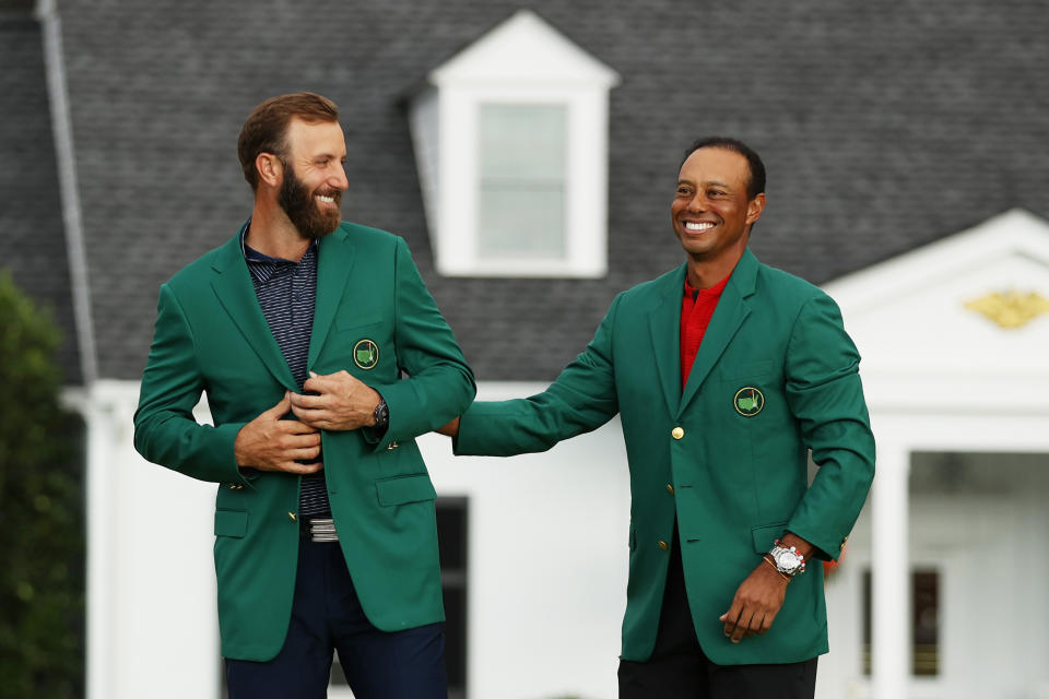 AUGUSTA, GEORGIA - NOVEMBER 15: Dustin Johnson of the United States is awarded the Green Jacket by Masters champion Tiger Woods of the United States during the Green Jacket Ceremony after winning the Masters at Augusta National Golf Club on November 15, 2020 in Augusta, Georgia. (Photo by Patrick Smith/Getty Images)