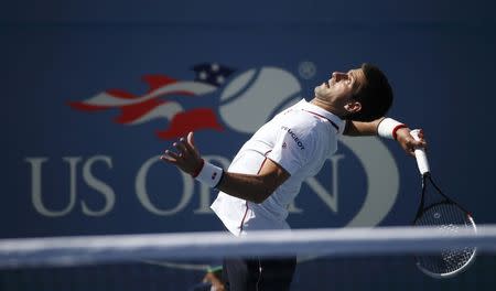 Novak Djokovic of Serbia serves to Paul-Henri Mathieu of France during their match at the 2014 U.S. Open tennis tournament in New York, August 28, 2014. REUTERS/Mike Segar