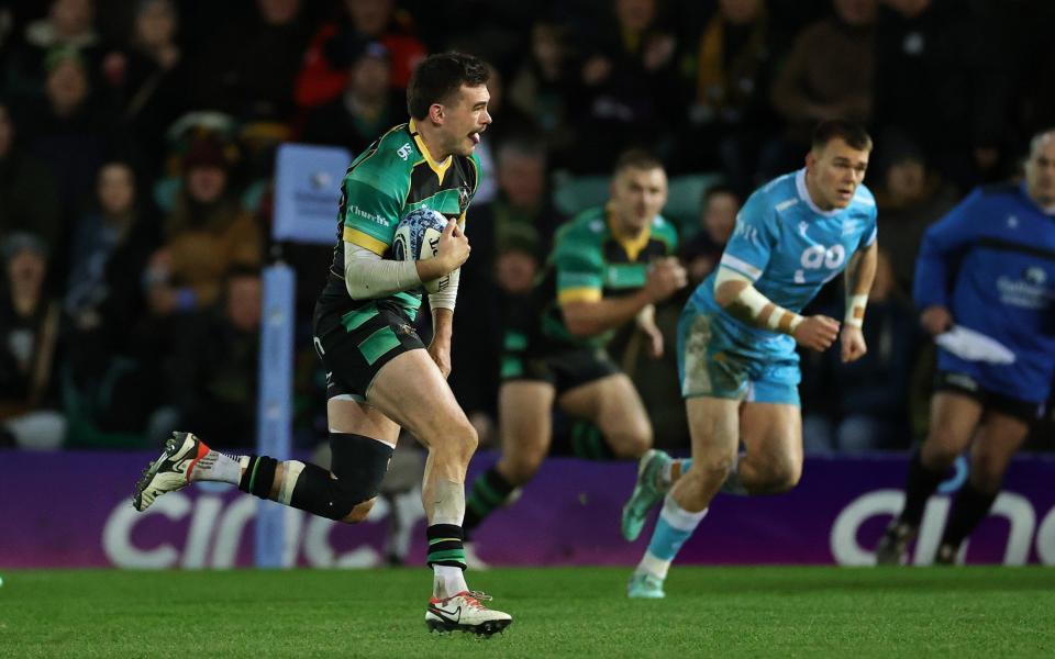 Northampton Saints' George Furbank breaks the ball to score their first try during the Gallagher Premiership Rugby match between Northampton Saints and Sale Sharks at Cinch Stadium at Franklin Gardens on December 30, 2023 in Northampton, England