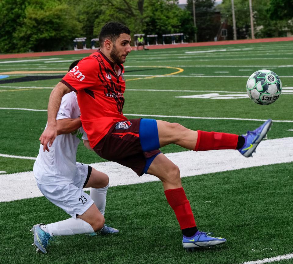 Lansing Common forward Ramzi Shaheen (11) controls the ball against Tulip City’s Marxus Lugo (23) in their home opener Saturday, May 21, 2022. The score ended in a 1-1 tie.