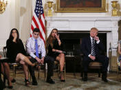 Marjory Stoneman Douglas High School shooting mother Melissa Blank (L) and surviving students Jonathan Blank (2nd L) and Julia Cordover (3rd L) react along with U.S. President Donald Trump as they listen to survivors and the relatives of victims during a listening session with high school students, family members and teachers to discuss school safety and shootings at the White House in Washington, U.S., February 21, 2018. REUTERS/Jonathan Ernst