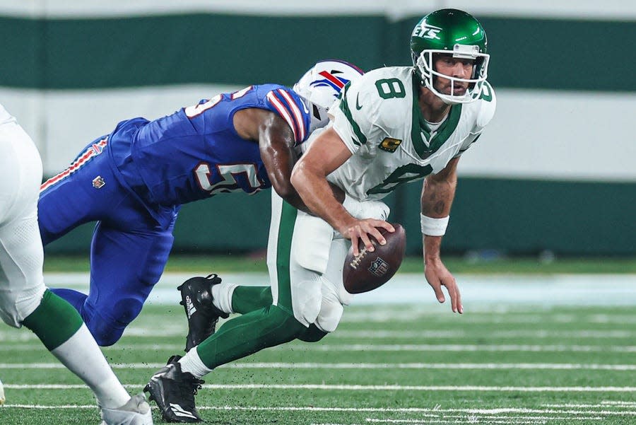 New York Jets quarterback Aaron Rodgers is injured while being sacked by Buffalo Bills defensive end Leonard Floyd on the team's first drive of the game Monday at MetLife Stadium.