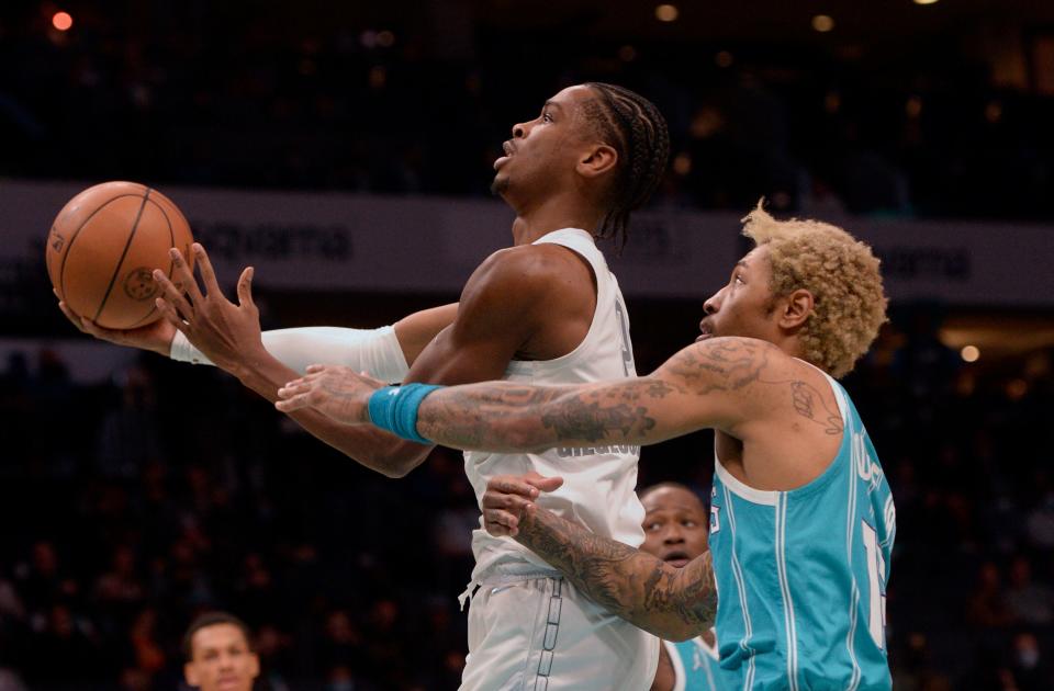 Jan 21, 2022; Charlotte, North Carolina, USA;  Oklahoma City Thunder guard Shai Gilgeous-Alexander (2) drives in as he is defended by Charlotte Hornets forward Kelly Oubre Jr. (12) during the first half at The Spectrum Center. Mandatory Credit: Sam Sharpe-USA TODAY Sports ORG XMIT: IMAGN-459500 ORIG FILE ID:  20220121_lbm_as1_076.JPG