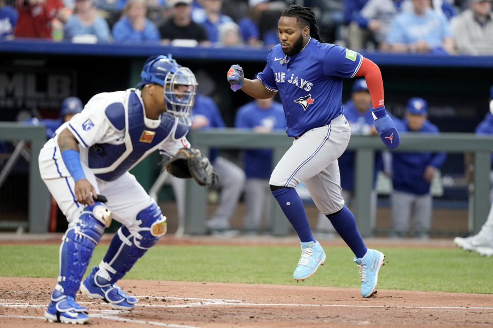 Toronto Blue Jays' Vladimir Guerrero Jr. runs home to score on a three-run triple hit by Bo Bichette during the third inning of a baseball game against the Kansas City Royals Monday, April 22, 2024, in Kansas City, Mo. (AP Photo/Charlie Riedel)