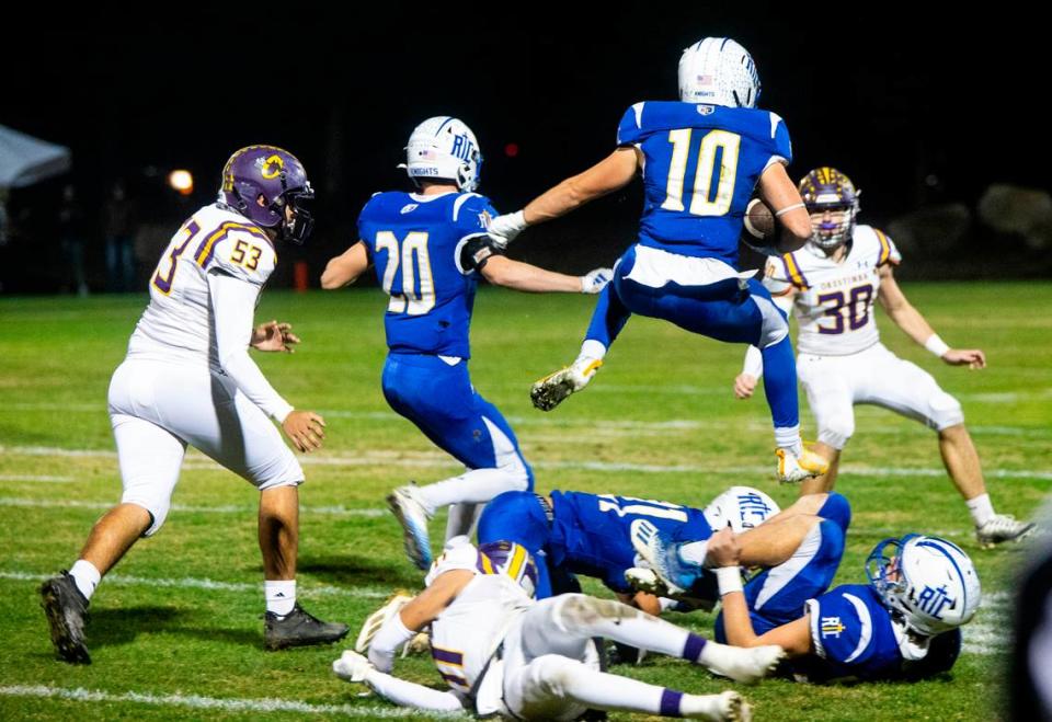 Ripon Christian’s Brady Grondz (10) leaps over a pile of defenders in the Sac-Joaquin Section Division VII-A Championship against Orestimba at Ripon Christian High School on Friday, Nov. 17, 2023.