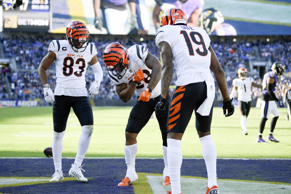 Cincinnati Bengals running back Joe Mixon, center, celebrates his touchdown run with wide receiver Tyler Boyd (83) and wide receiver Auden Tate (19) during the second half of an NFL football game against the Baltimore Ravens, Sunday, Oct. 24, 2021, in Baltimore. (AP Photo/Nick Wass)