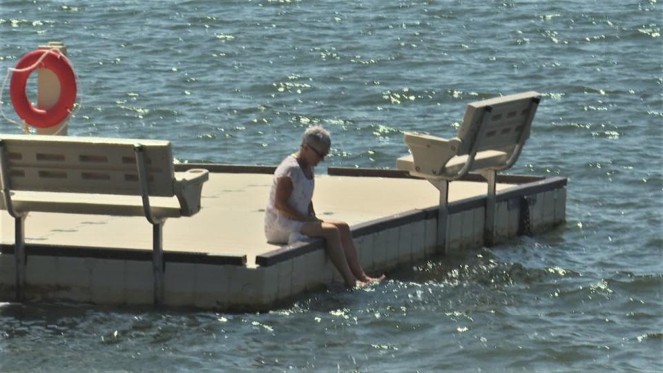 A woman cools her feet in Charlottetown Harbour, July 24, 2023.