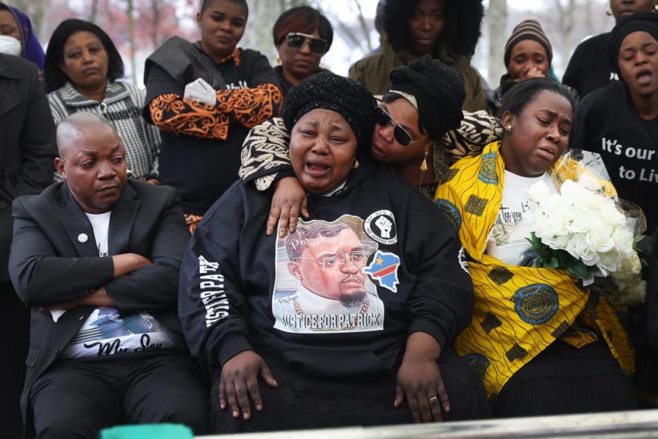 <div class="inline-image__caption"><p>Dorcas Lyoya (C), the mother of Patrick Lyoya, is comforted as she grieves the loss of her son while he is laid to rest at Resurrection Cemetery on April 22.</p></div> <div class="inline-image__credit">Scott Olson</div>