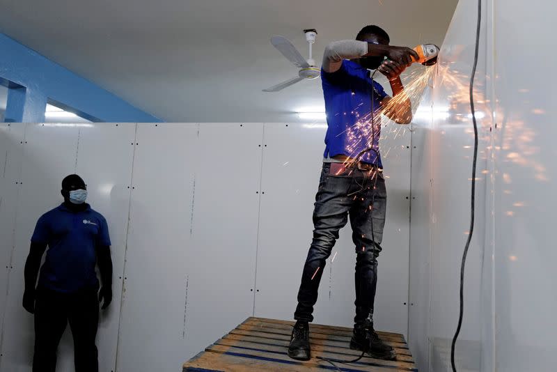 FILE PHOTO: Workers prepare new cold rooms to store the country’s stock of vaccines, including those for COVID-19, at the Fann Hospital in Dakar