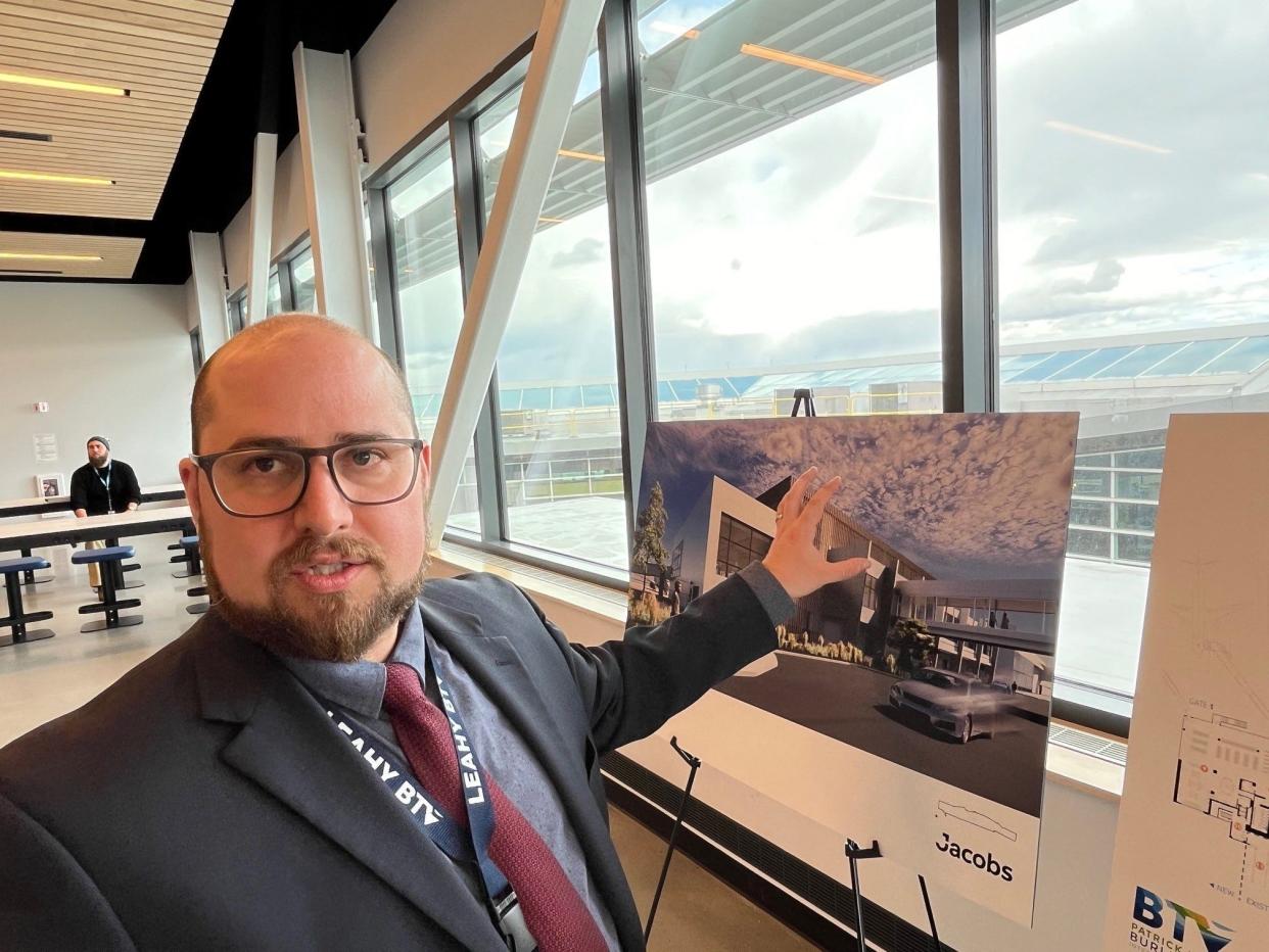 Aviation Director Nic Longo points to an artist's rendering of the planned new north terminal at Patrick Leahy Burlington International Airport during a press conference on March 20, 2024.