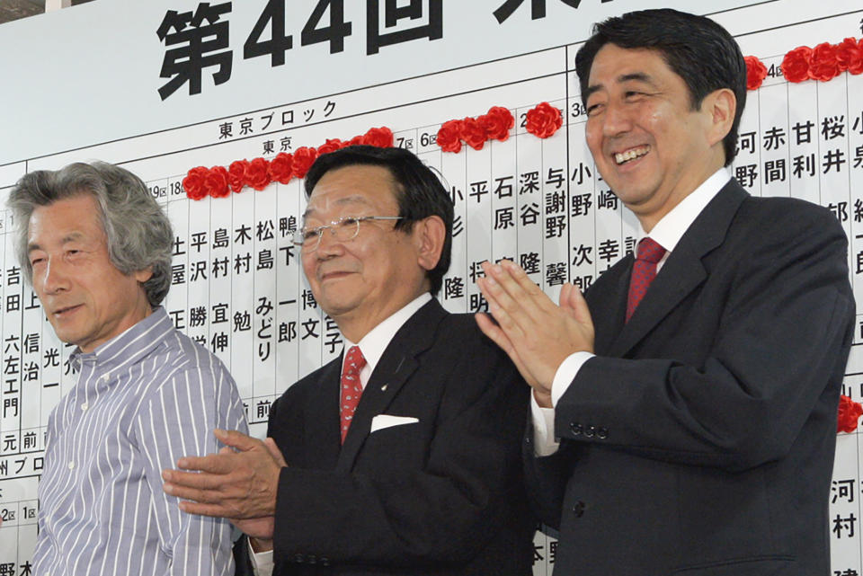 Japan's then Deputy Secretary-General of the Liberal Democratic Party Shinzo Abe, right, celebrates with then Prime Minister Junichiro Koizumi, left, as the party won at an election of the House of Representatives in Tokyo in September 2005. In 2005, Abe was appointed chief cabinet secretary under Prime Minister Junichiro Koizumi, during which he leads negotiations to return Japanese citizens abducted to North Korea. (Kyodo News via AP)